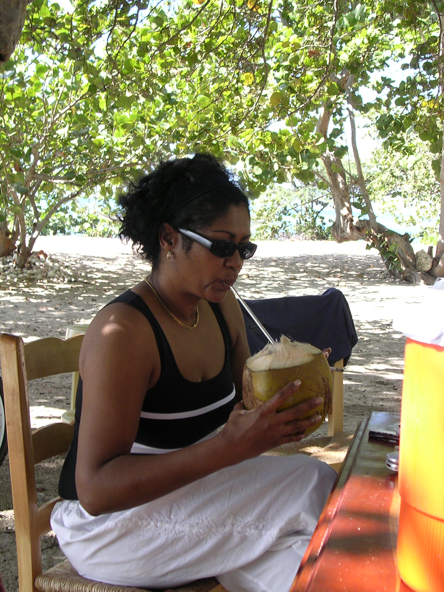 woman sipping coconut in Haiti