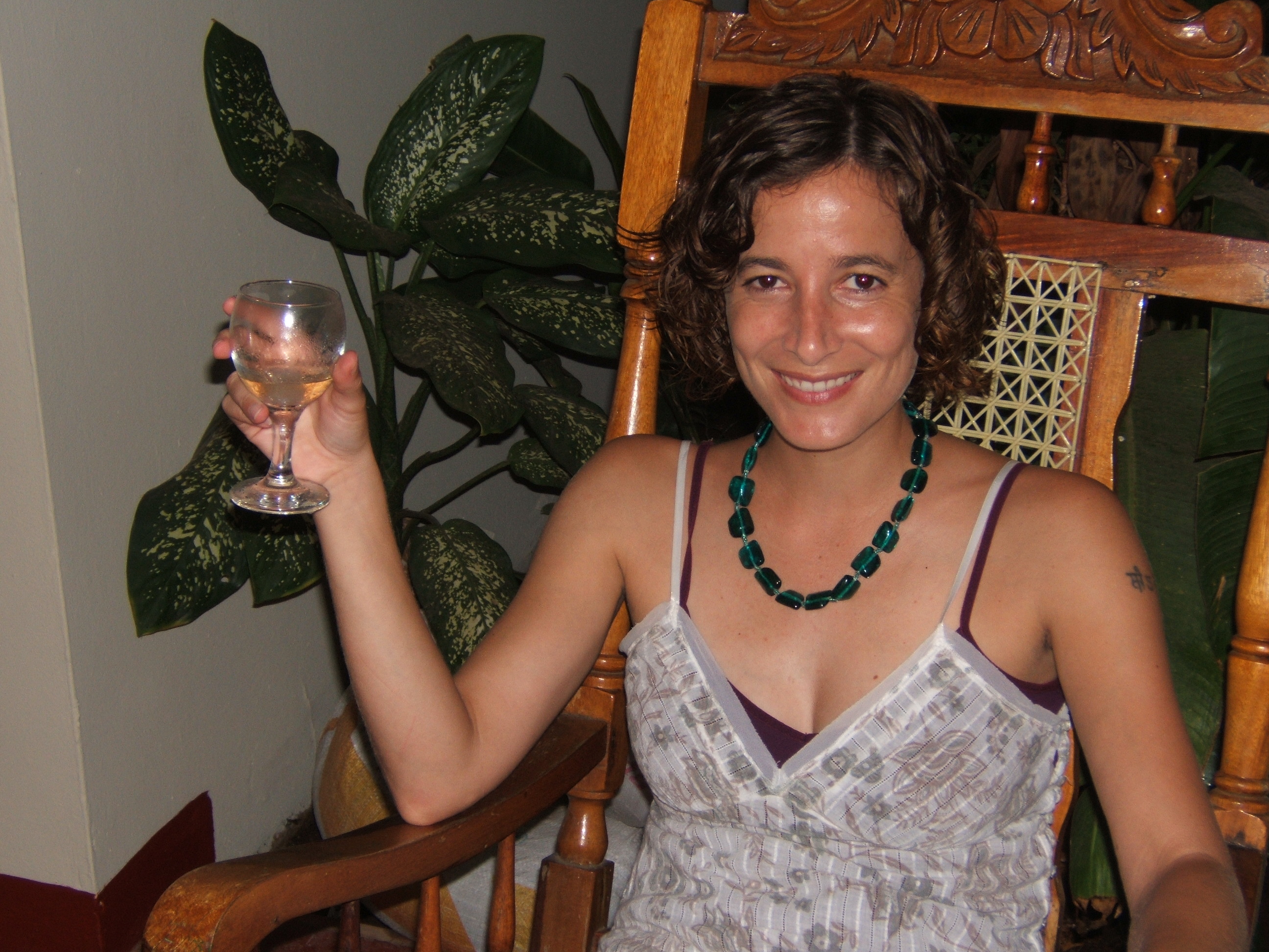 girl drinking glass of wine in rocking chair