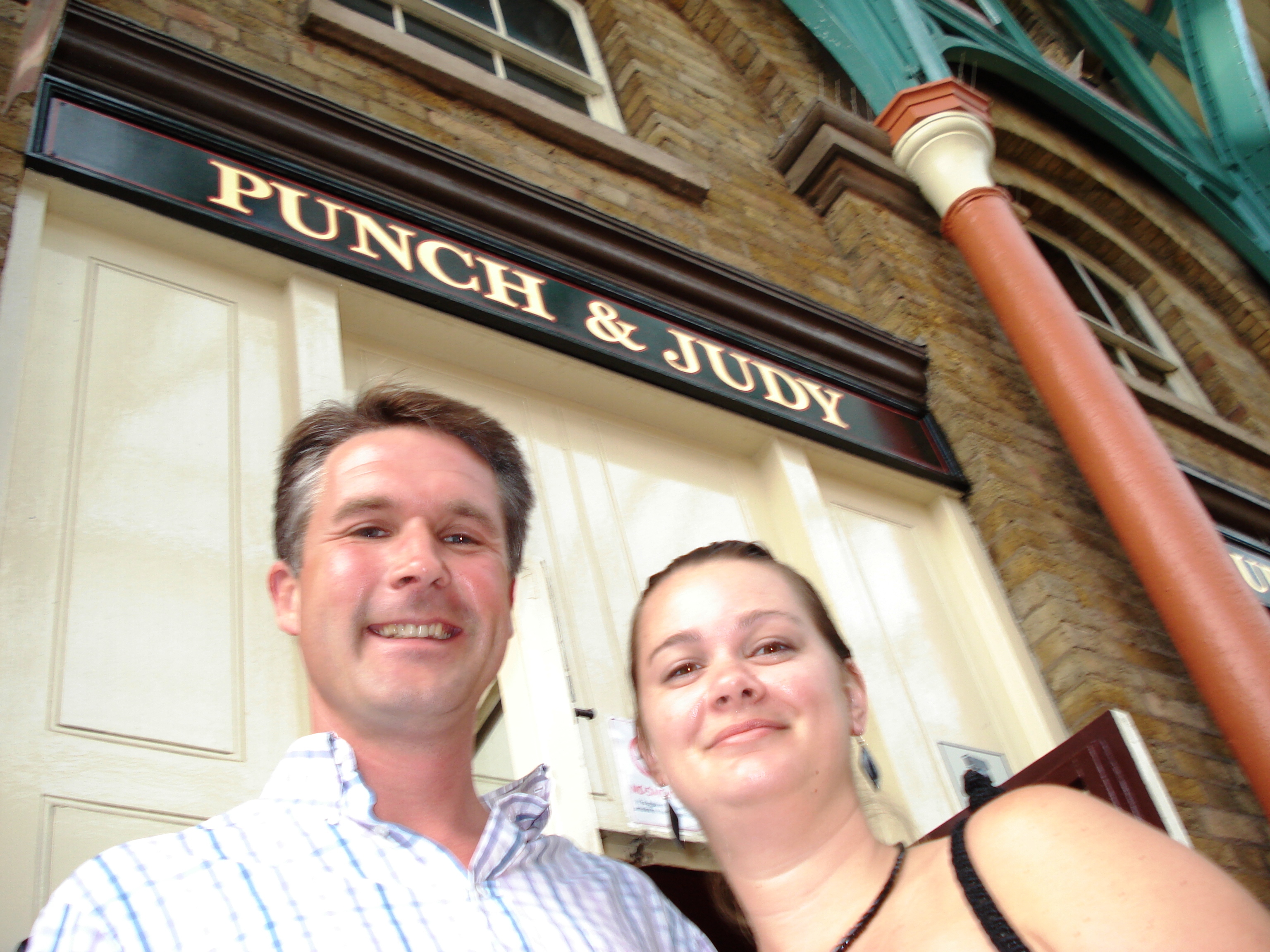couple in front of Punch and Judy sign in London