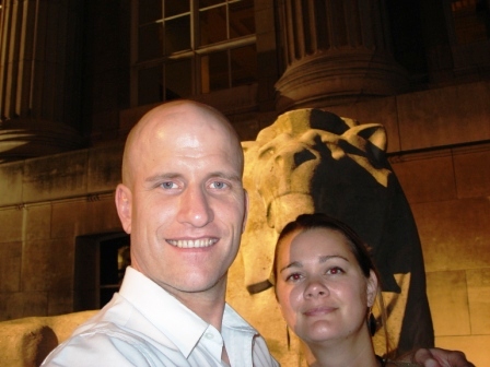 couple in front of lion at British Museum at night