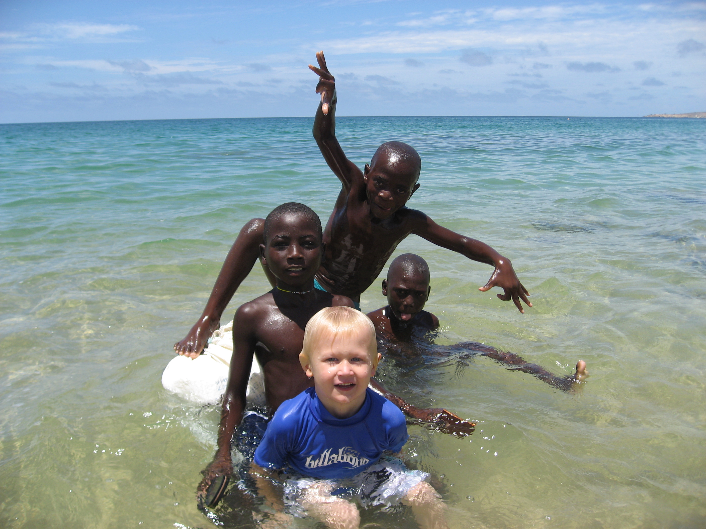 four boys on a float in ocean in Angola