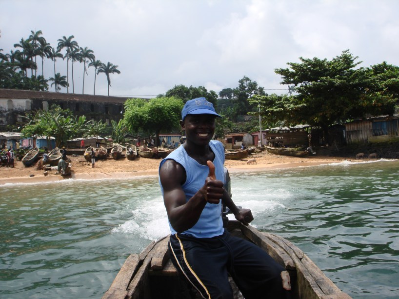 man in canoe sao tome beach