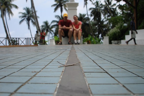 couple sitting on equator line sao tome island