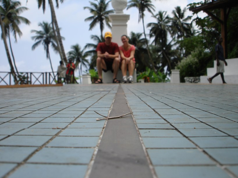 couple sitting on equator line sao tome island