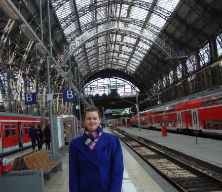 woman in long coat at frankfurt train station