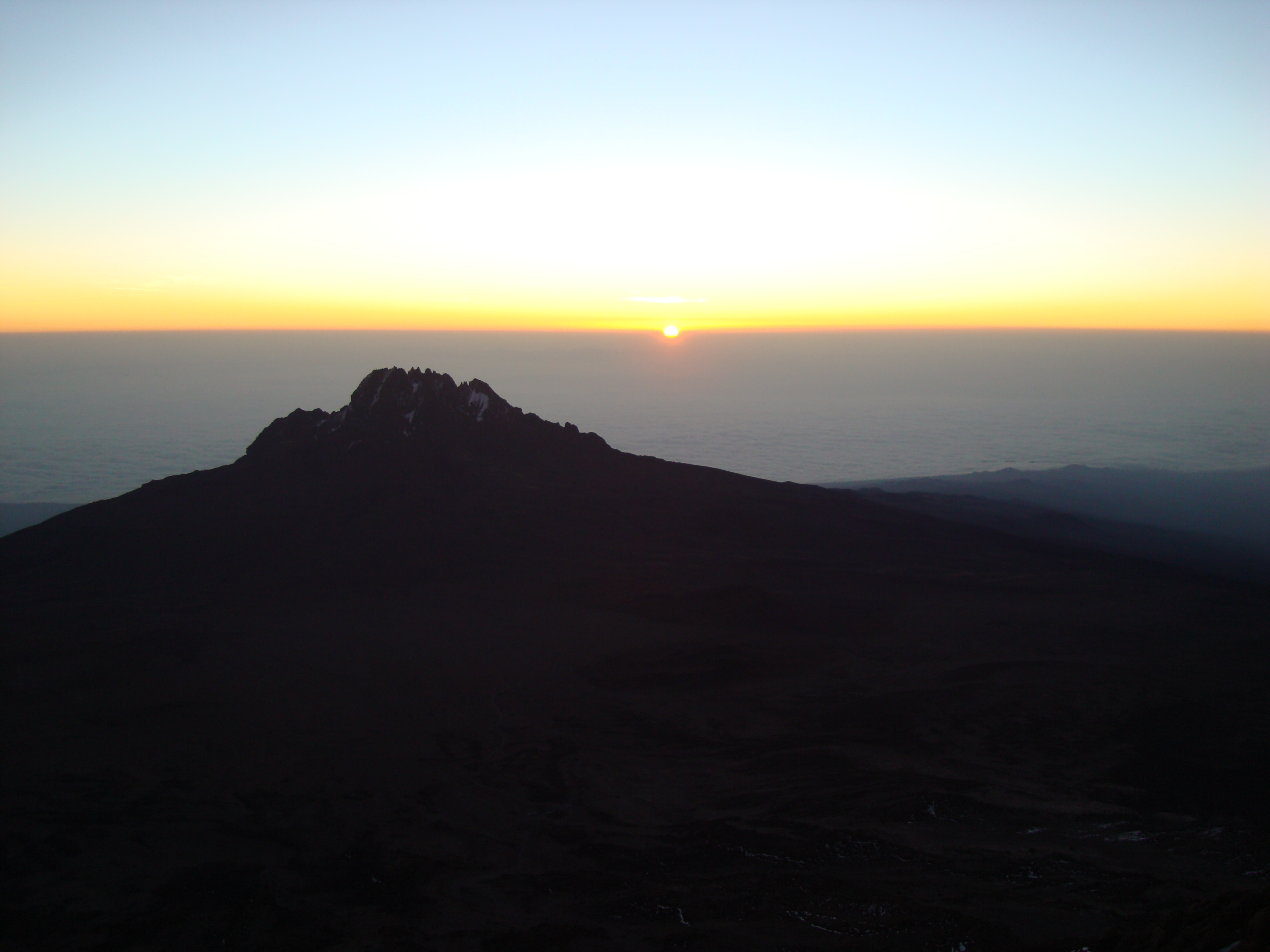 sunrise from the top of mount kilimanjaro tanzania overlooking mount kenya