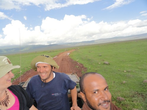 three friends on safari game drive ngorongoro creater kenya tanzania