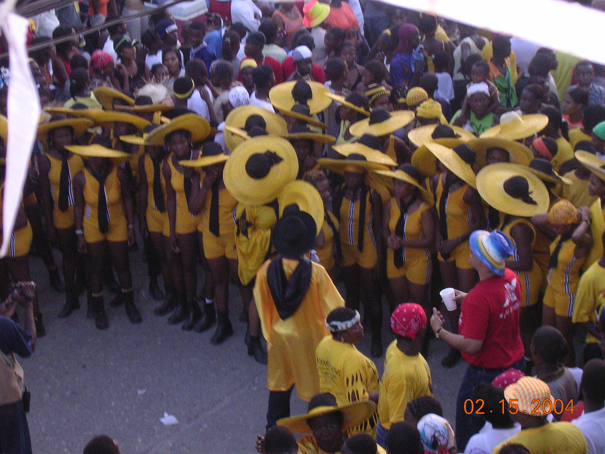 yellow and black hat ladies dancing at jacmel carnival haiti