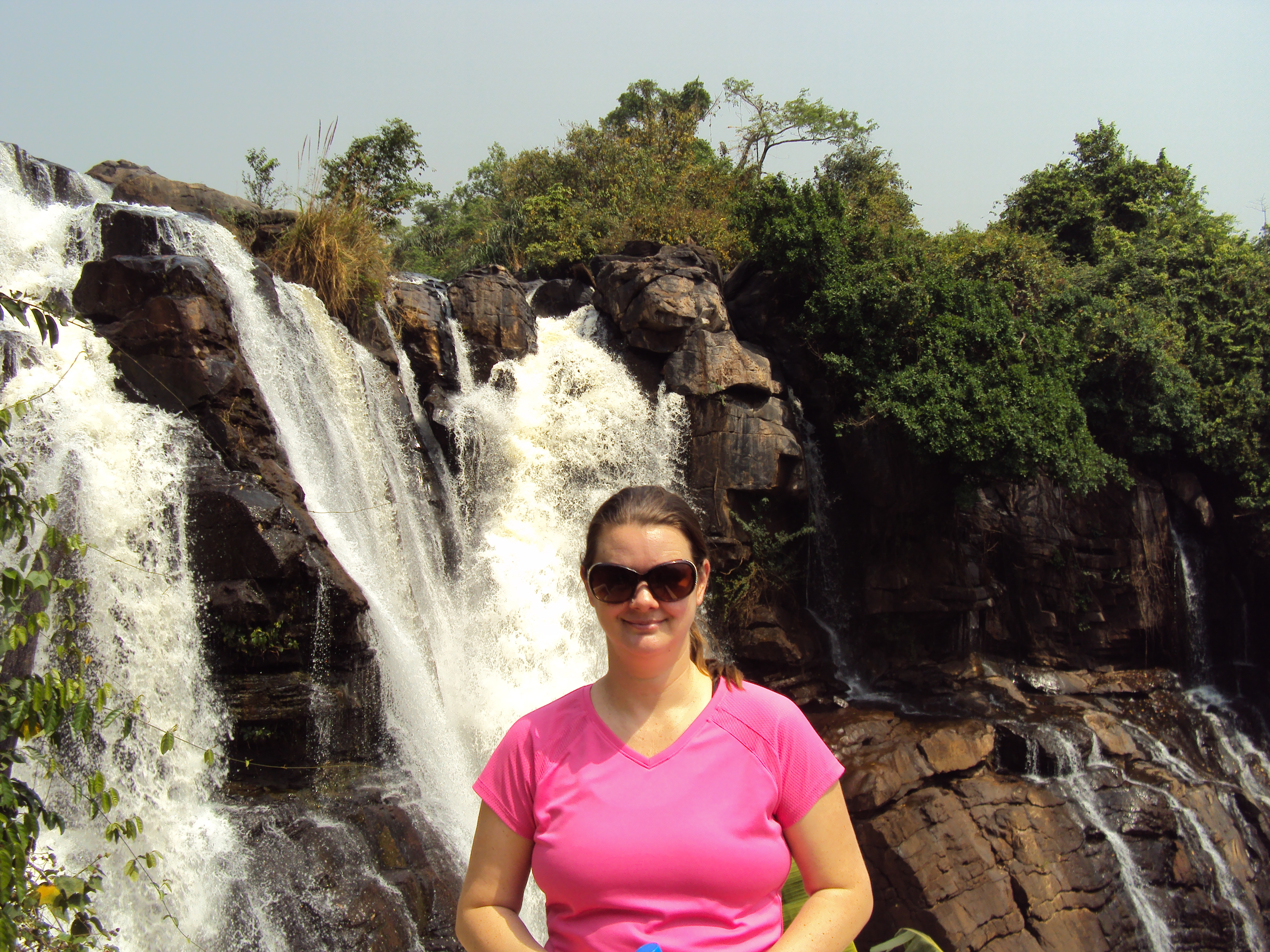 lady standing at Boali waterfall central african republic