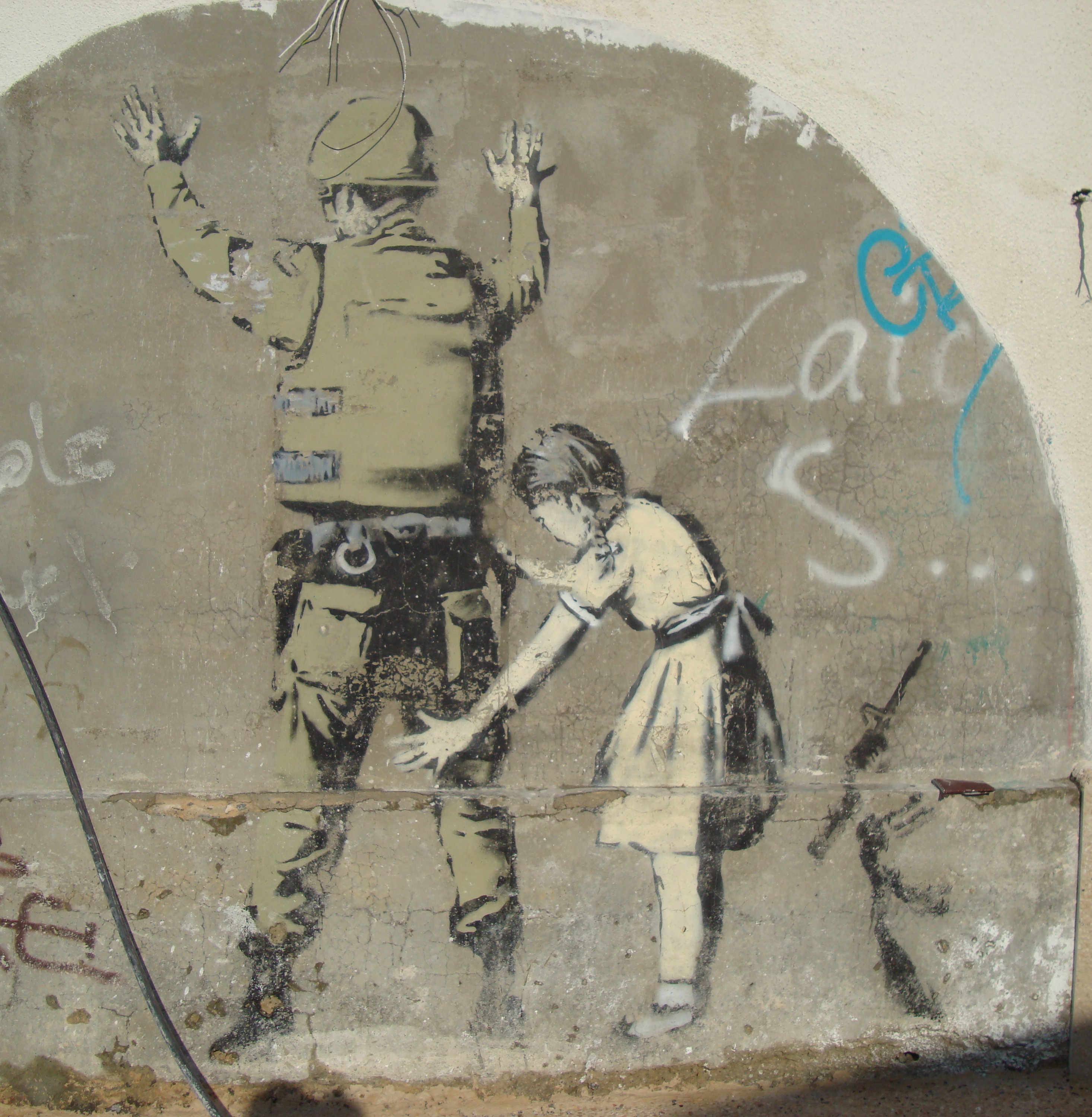 west bank street art palestine little girl patting down soldier banksy