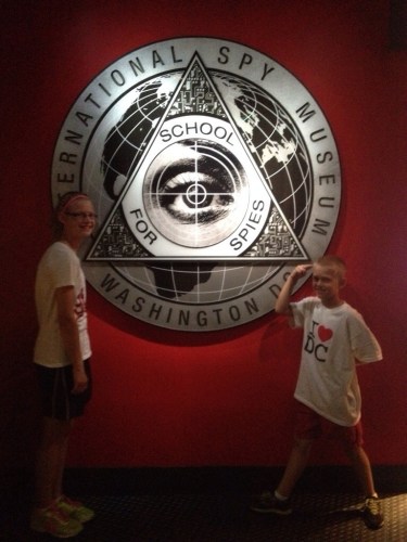 Kids in front of International Spy Museum sign Washington DC