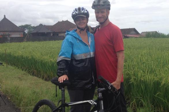 Deah and Chris on bikes in Bali rice field Ubud
