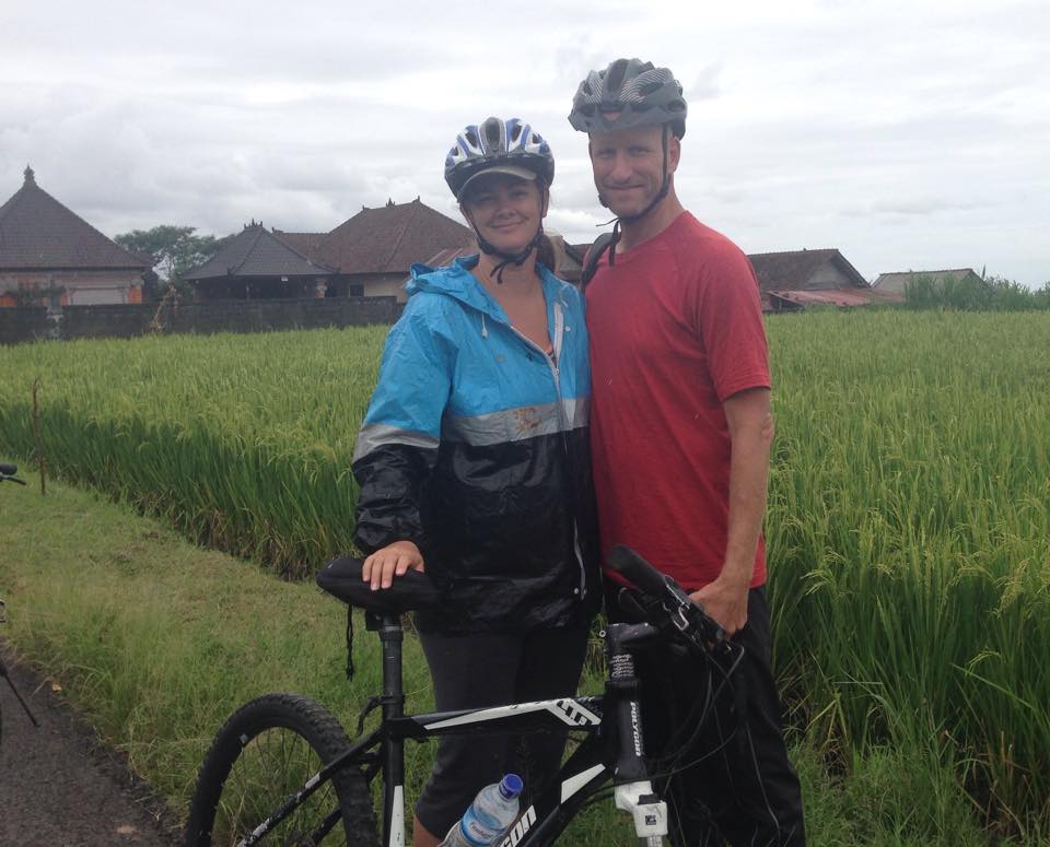 Deah and Chris on bikes in Bali rice field Ubud