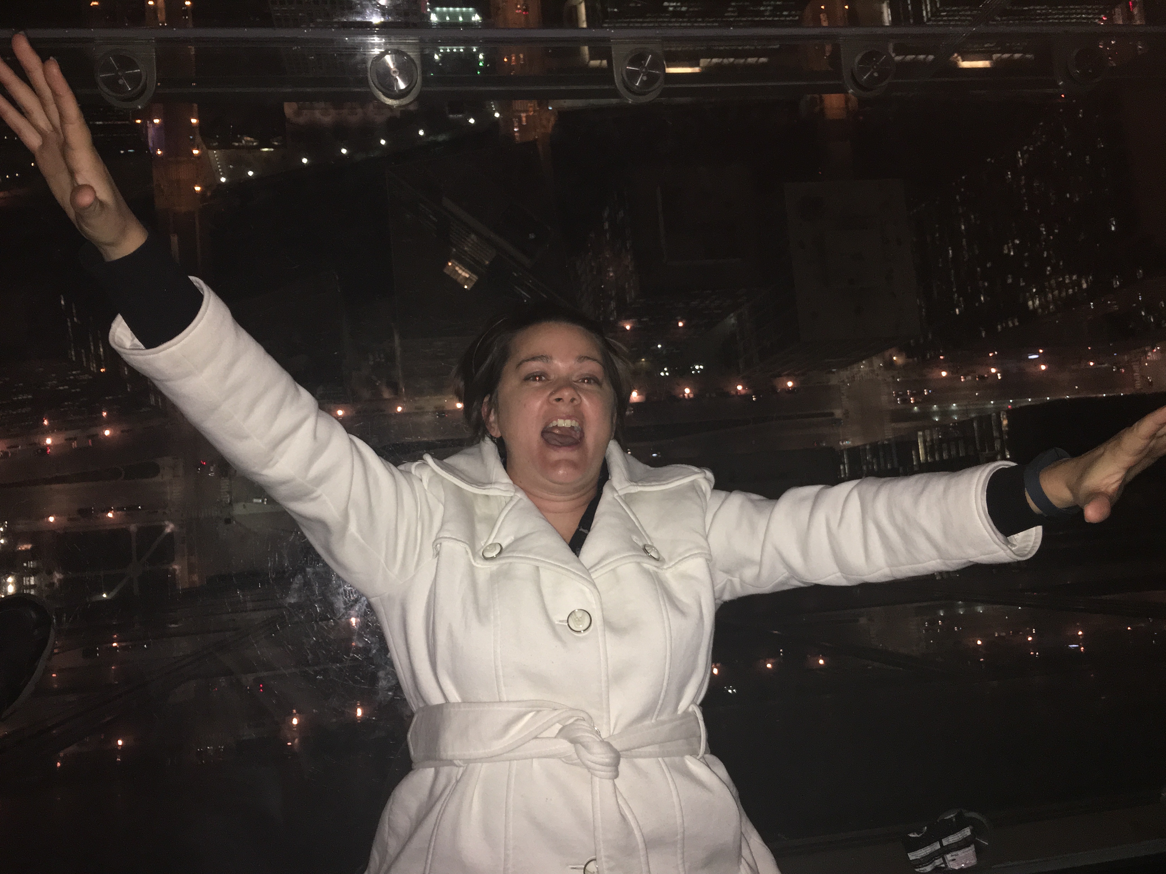 Deah laying on skydeck glass floor in chicago willis tower