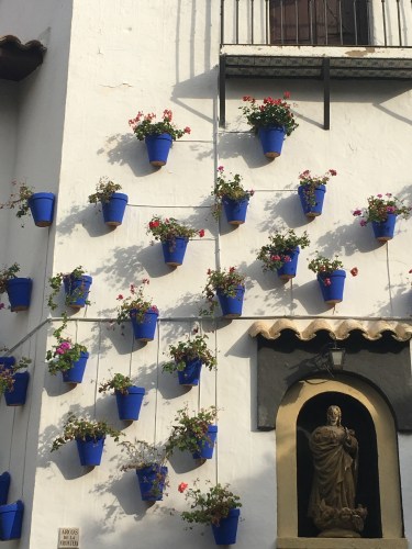 blue terra cotta pots outside white andalusian house