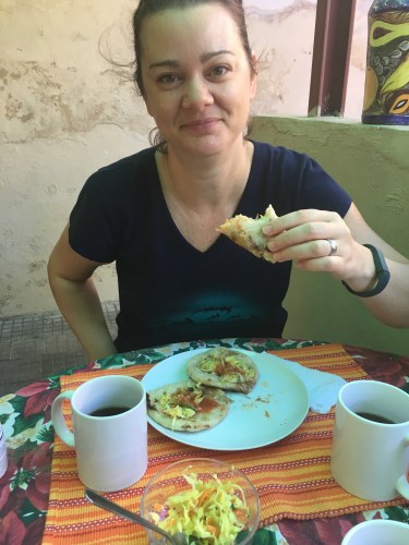 Deah eating Papusas and hot chocolate in Santa Ana El Salvador