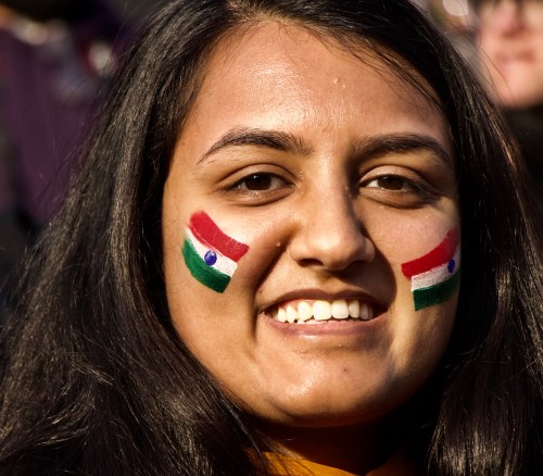 smiling woman with Indian face paint flag Wagah Border Ceremony
