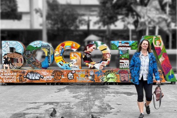 woman walking in front of letters that spell out Bogotá